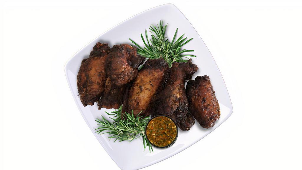 Spicy Jerk Wings Meal · Enjoy flavor infused bone-in wings seasoned and marinated in our house blend jerk seasoning, garnished with peppers and onions, and served with herb butter basmati rice and black beans.