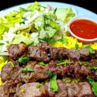 Lamb Shashlik (8Oz) · Skewered and grilled cubes of lamb served with fresh salad, tomato sauce, and steamed rice
