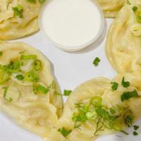 Manti (Meat) · Steam cooked dumplings filled with beef+lamb and veggies. Five pieces in a portion.