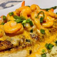 French Quarter Red Fish · broiled or blackened, topped with shrimp in a spicy cream sauce, with mixed veggies & poblan...