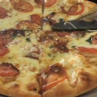Margarita Pizza · Fresh basil, olive oil, tomatoes, garlic, and mozzarella cheese.