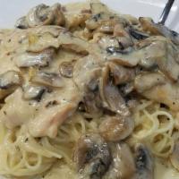 Spaghetti Carbonara · Served with black olives, mushrooms, Canadian bacon in a creamy sauce.
