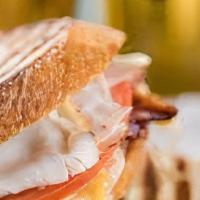 Turkey Club · Ciabatta roll with mayo, Swiss, tomato, bacon, and sliced turkey.