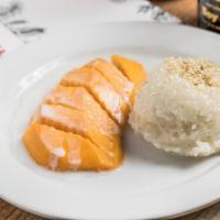 Sticky Rice W/ Mango · fresh mango slices over sticky rice smothered in sweet coconut milk topped with sesame seeds