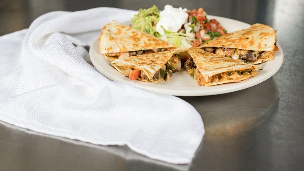Kids Quesadilla · Cheese, chicken, or ham quesadilla served with French fries and a side of sour cream.
