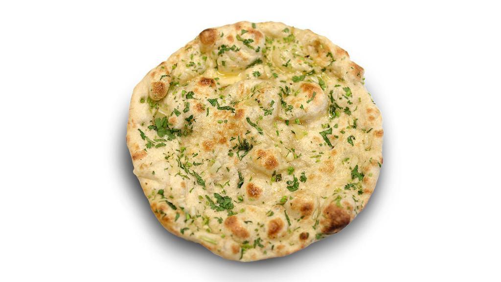 Garlic Naan · Our famous home made naan with an added layer of fresh garlic and cilantro, then baked in a tandoor clay oven, comes out soft and crispy steaming with a light butter glaze.