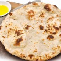 Naan · Our famous and unique in-house flatbread baked in a tandoor clay oven. This bread is rolled ...
