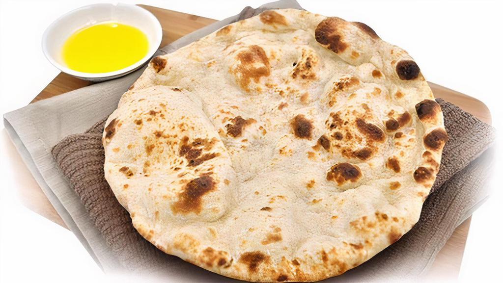 Naan · Our famous and unique in-house flatbread baked in a tandoor clay oven. This bread is rolled thick, and comes out soft and crispy, steaming with a light butter glaze.