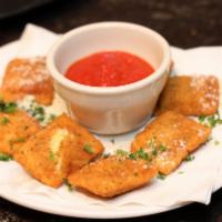 Toasted Ravioli · Slightly breaded ravioli stuffed with ricotta and parmesan cheese served with our homemade m...