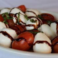 Caprese  Salad · Grape tomatoes, mozzarella cheese, fresh basil and balsamic glaze
