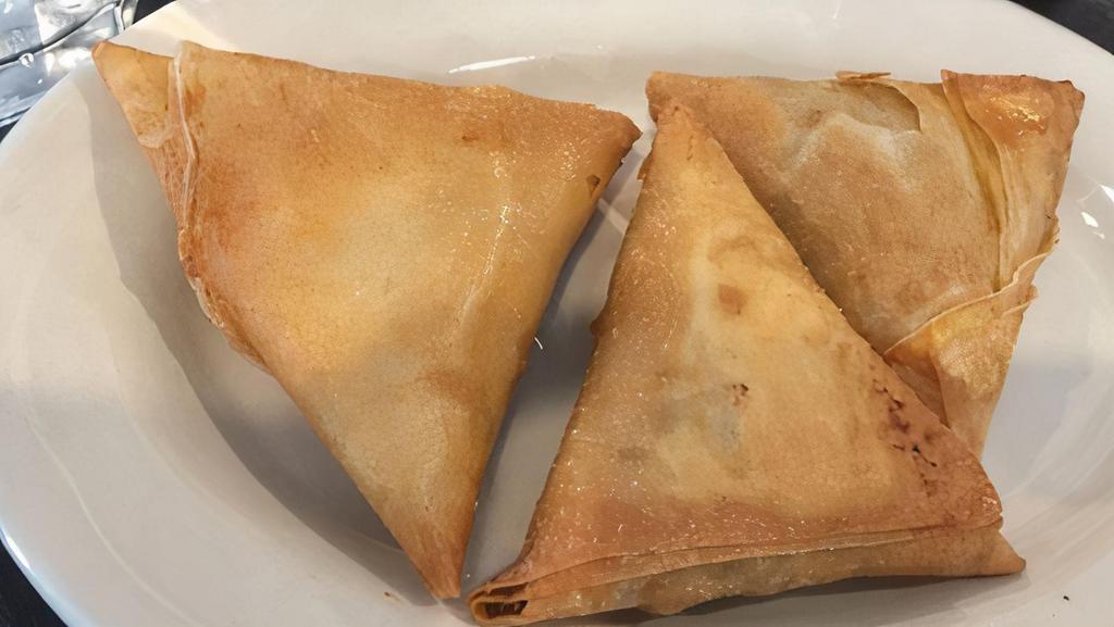 Samosas (3Pc) · Triangular pastries filled with seasoned ground beef and fried for a golden crisp crust.