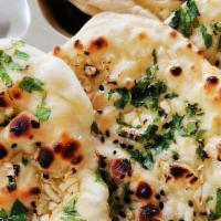 Garlic Naan · Traditional naan topped with garlic butter and parsley.