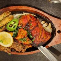 Mix Grill Platter · Combination of tandoori chicken, bihari kabob, beef seekh kabobs and chicken boti served wit...