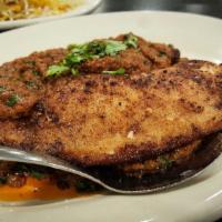 Fish Masala · Fresh fish fillet cooked in a blend of house spices, tomatoes, ginger and coriander then dus...