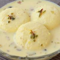 Ras Malai A Royal Delight · Milk and flour patties soaked in rich cream embellished with saffron, pistachios and rose sy...