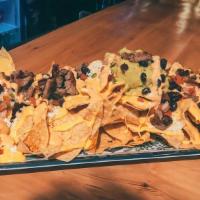 Killer Nachos (To Share Platters) · Corn tortilla chips, layered, stacked and loaded with guacamole, black beans, pico de gallo,...