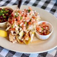 Grilled Tilapia Tacos · Three crispy corn tortillas stuffed with grilled tilapia, , pico de gallo, coleslaw, and com...