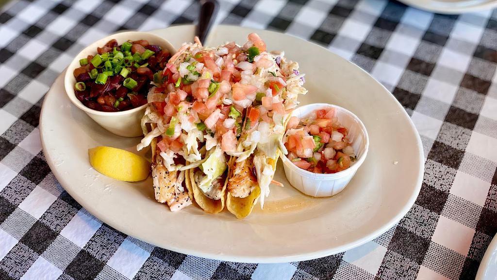 Grilled Tilapia Tacos · Three crispy corn tortillas stuffed with grilled tilapia, , pico de gallo, coleslaw, and comeback dressing served with rice and beans.