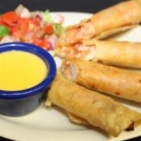 Chicken Flautas Con Queso · Crispy corn tortillas stuffed with ranchero chicken and Pepper Jack cheese. Served with chil...