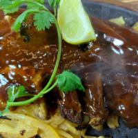 Mexican Style Baby Back Ribs · Half rack of our tender, slow smoked baby back ribs basted with red river's famous sauce.