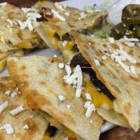 Beef Fajita Quesadillas · Served with guacamole sour cream jalapeños chips and red salsa.