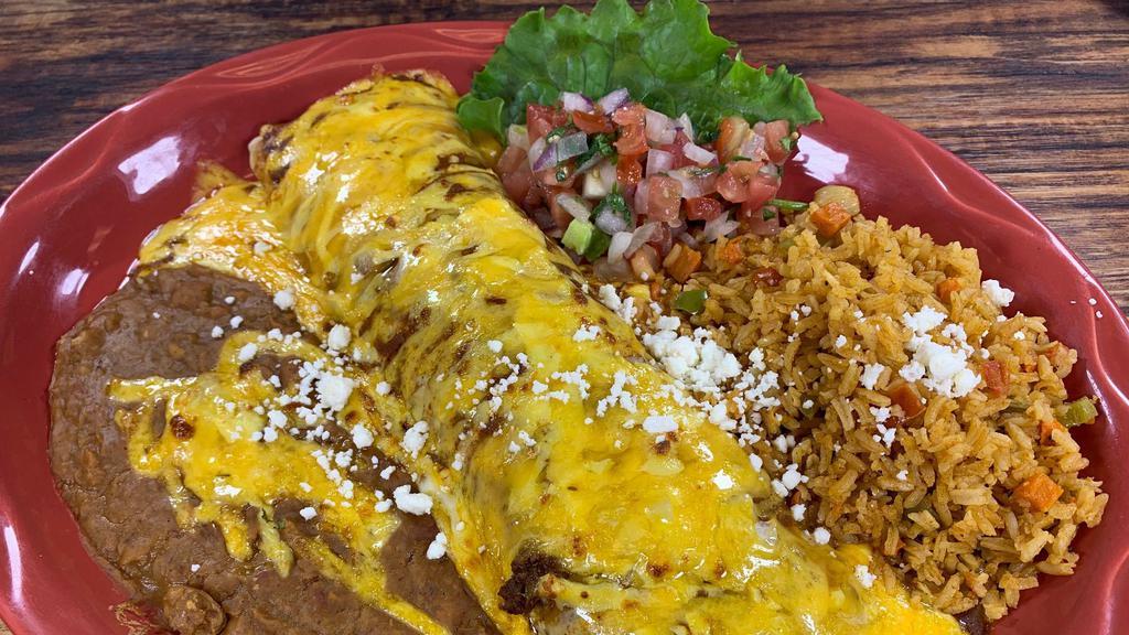 Burrito Classico - Chicken Fajita · Chicken fajita, rolled in a homemade flour tortilla with refried beans and chile con queso. Topped with our chile con carne and grated cheese with pico de gallo on the side.
