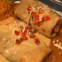 Chimichangas - Beef Fajita · Two chimichangas loaded with refried beans, fajita & cheese then lightly fried.  Topped with...