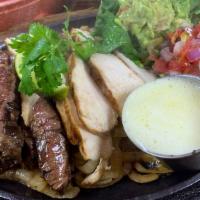 Beef Fajitas For One · Tender outside skirt steak and fresh chicken breast grilled over mesquite. includes mexican ...