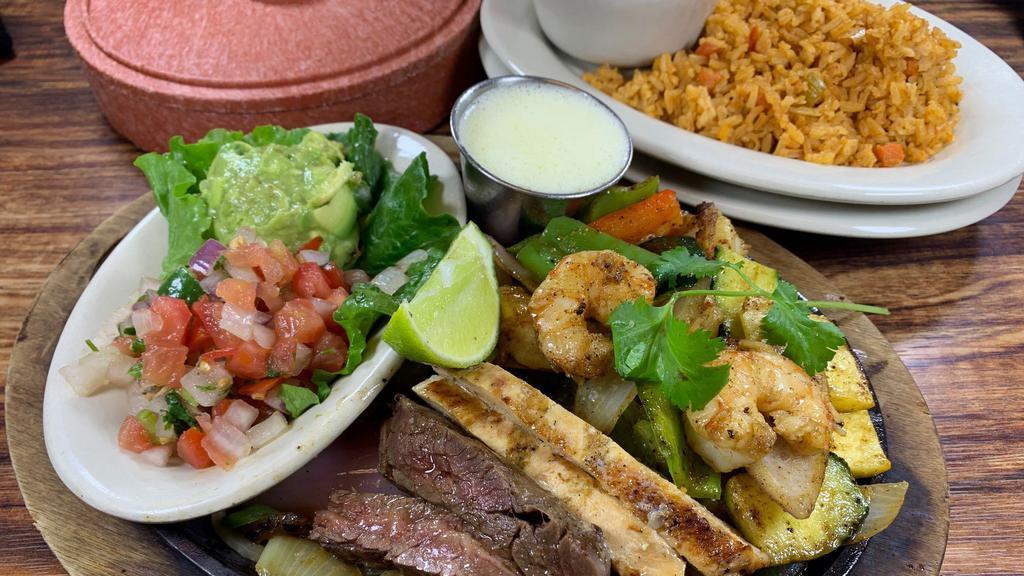 Shrimp, Beef & Chicken Fajitas · Grilled shrimp, Beef & Chicken Fajitas with onions, bell peppers, zucchini and squash.