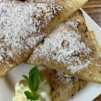 Sopapillas · Served with powdered sugar and honey.