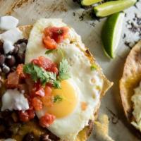 Huevos Rancheros · Two eggs sunny side up topped with salsa over a corn tortillas 
with  refried beans and pota...