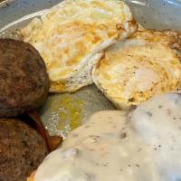 Biscuit & Gravy Omelet · Three egg omelet stuffed with biscuits, Monterey Jack and Cheddar cheese, and smothered in h...