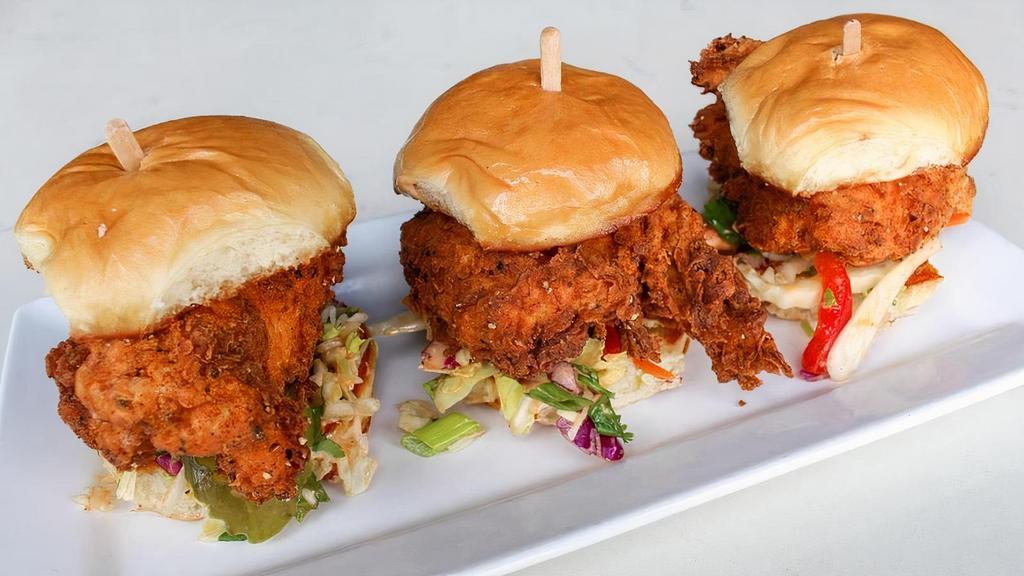 Spicy Fried Chicken Sandies · Tender chicken marinated jalapeño & buttermilk, dusted in spicy flour and crispy fried.Topped with Chipotle Slaw and dill pickles on a toasted brioche bun . 3 ea.