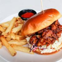 The Smokin' Outlaw · Smoked beer BBQ pork topped with Sriracha mayo and Southern Slaw on a toasted brioche bun.