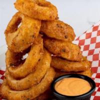 Beer Battered Onion Rings · Lightly fried and served with choice of peppercorn ranch or Sriracha dipping sauces.