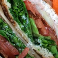 Italian Turkey Club Sandwich · Turkey breast, green leaf lettuce, tomato, Mozzarella cheese, turkey bacon, and pesto sauce....
