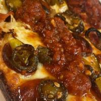 4 Cylinder - Texas Sweet Heat Pizza · Detroit style dough and brick cheese topped with old world pepperonni, candied jalapenos, pe...