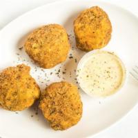 Boudin Balls · Cajun inspired boudin balls fried in cornmeal and served with remoulade.