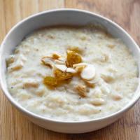 Kheer · Sweet rice pudding flavored with black cardamom and nuts