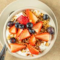 Yogurt, Fruit, Nuts & Granola Parfait · Vanilla yogurt, mixed berries, nuts, and crunchy granola layered in a bowl.