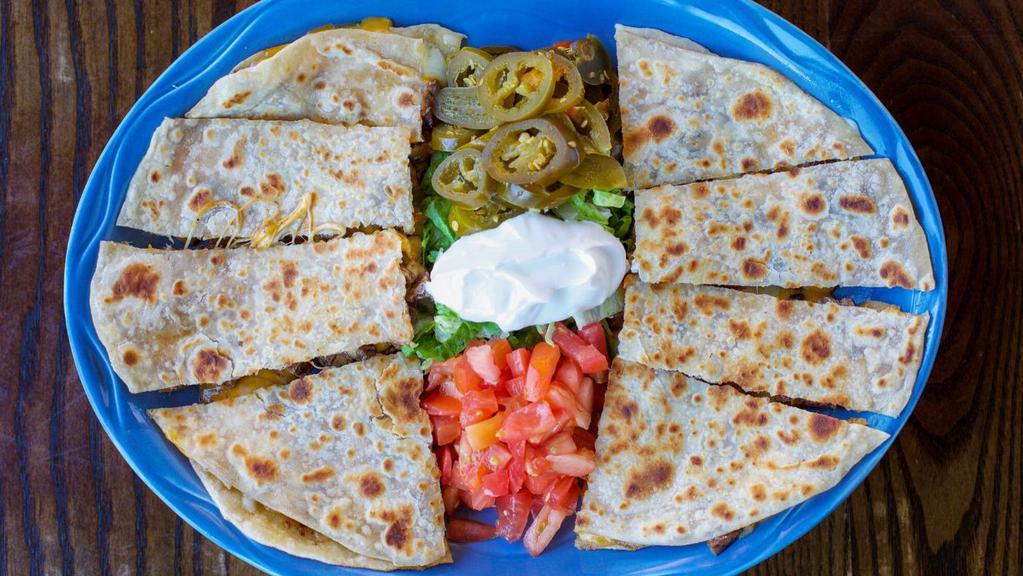 Fajita Quesadillas · Popular item. Grilled flour tortilla stuffed with melted cheddar and jack cheese. Choice of choice of fajita beef or fajita chicken. Served with sour cream, guacamole, pico de gallo.