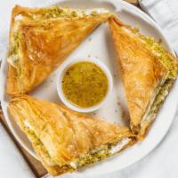 Knafeh · Homemade, sweet cheese, topped with shredded filo dough, pistachio and soaked in hot syrup.