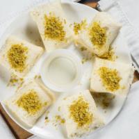 Halāwat Al-Jibn · (Sweet cheese) is an Arabic dessert made of a semolina and cheese dough, filled with sweet c...