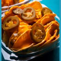 Nachos · Delicious Nachos with cheese topped with Jalapenos.