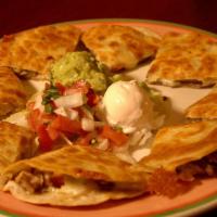 Fajita Quesadillas · Grilled flour tortillas filled with your choice of beef or chicken fajita meat served with s...