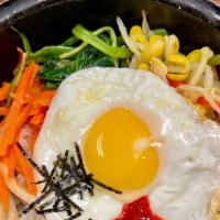 Bibimbap · Assorted vegetables with bulgogi, sunny-side up 
egg, chili paste, and dry seaweed over rice