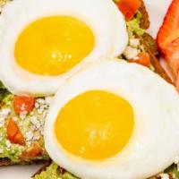 Avocado Toast Topped With 2 Eggs · Healthy avocado smashed to order with paprika + black pepper on toasted whole grain wheat, t...