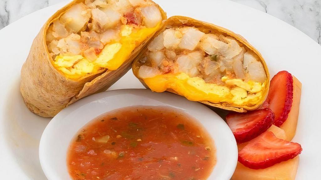 Breakfast Burrito · Scrambled eggs, potatoes, cilantro, serrano pepper, Cheddar, and sauce in a tomato herb tortilla. Served with choice of side.