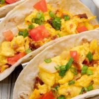 Breakfast Tacos · Stuffed with scrambled eggs, our thick bacon, fresh tomatoes, onion and aged cheddar cheese....
