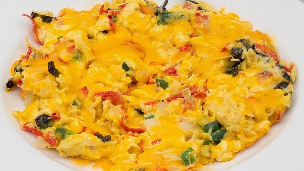 Migas · Scrambled eggs, onion, fresh jalapeno, tomato, tortilla strips, aged Cheddar, and salsa. Served with choice of side and flour tortillas.